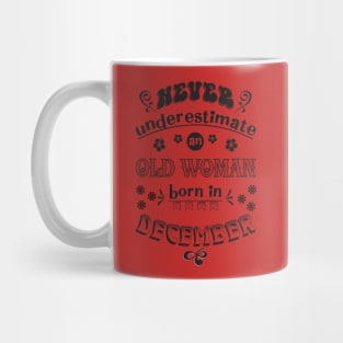 Never underestimate Woman December Mug